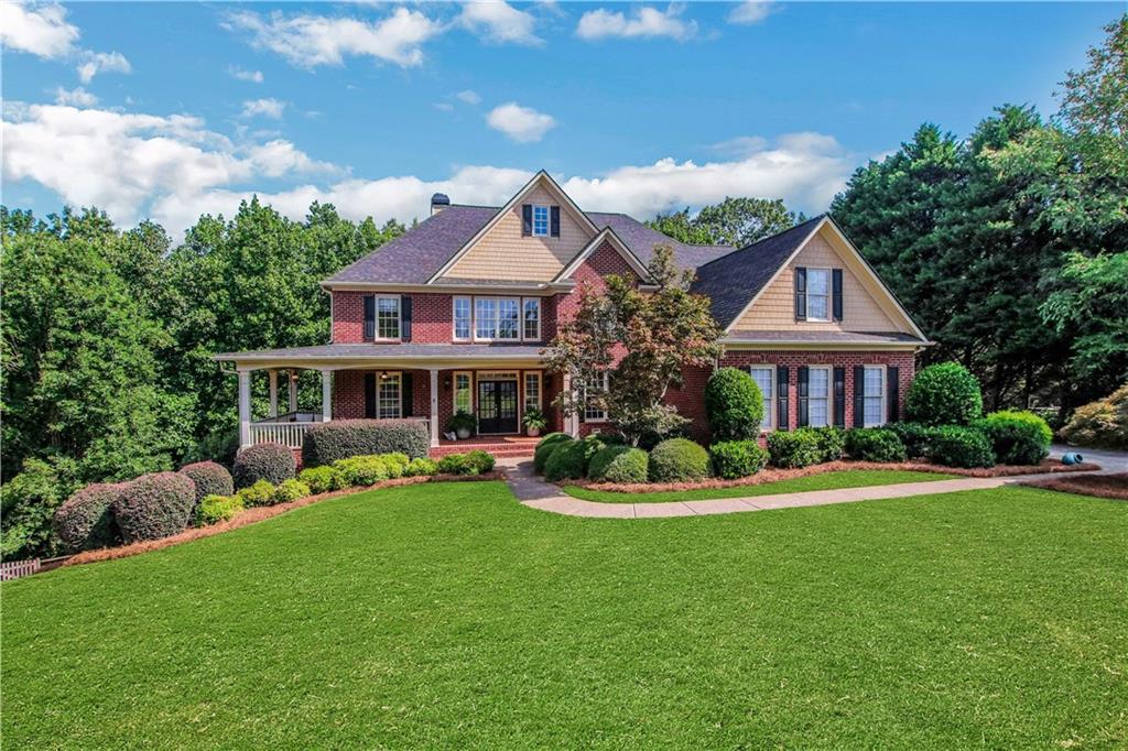 Discover an incredible opportunity in the highly sought-after Chattahoochee River Club, one of South Forsyth’s most prestigious and vibrant communities—zoned for the award-winning South Forsyth High School and just a short walk or golf cart ride to top-rated elementary and middle schools. This stunning 6-bedroom, 5-bathroom residence, nestled on a peaceful cul-de-sac, boasts a classic three-sided brick exterior, an inviting wrap-around front porch, a spacious 3-car garage, and a versatile finished basement perfect for entertaining or creating your dream space. Step inside to a timeless, thoughtful floorplan ready for your personal touch. With a little updating, this home is poised to become your perfect haven. The main level features a bedroom and full bath, ideal for guests or multi-generational living. Upstairs, a versatile bonus room offers endless possibilities—think playroom, teen lounge, or cozy media space. The heart of the home is the chef-inspired kitchen, complete with granite countertops, stainless steel appliances, and a premium Sub-Zero refrigerator, seamlessly flowing into the main living areas for effortless gatherings. Beyond the home, Chattahoochee River Club offers a true lifestyle. Enjoy three resort-style pools, a competitive swim team, tennis and pickleball courts, and miles of scenic walking trails along the tranquil Chattahoochee River. Whether you’re relaxing on your charming porch, exploring the neighborhoods by golf cart, or envisioning the updates that will make this gem uniquely yours, this home is a remarkable canvas for the best of South Forsyth living.