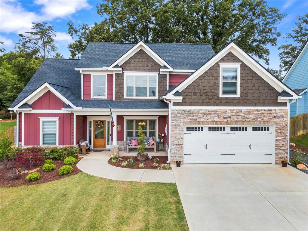 Look no further!! This beautiful ranch home with private outdoor living space on a wooded lot is perfect for you!! Enjoy the fire-pit, expansive patio, and cookout on your grill that can be hooked up to an outdoor gas line. On the main level, you will find an oversized owner's suite with spacious bathroom and walk-in closet. The eat in kitchen has many cabinets, a large pantry, and views into the family room. The open floor plan is suitable for hosting and entertaining guests. All the cabinets in the house have the soft close feature and the home has lots of storage on the upper level and attic. Secondary bedrooms upstairs are spacious and share a bathroom along with a big bonus room. Downtown Ball ground is great, with shopping, dining, brewery, winery and parks - you will want to check it out!