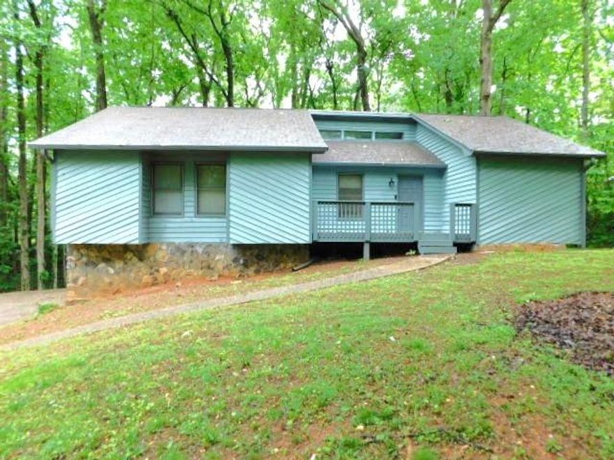 Renovated rustic ranch home with front deck/porch.  You enter into an oversized family room with vaulted ceiling, ceiling fan, gas log fireplace and access to the rear wood deck. .  There is stairs that need to the unfinished basement and drive under garage. There is a separate dining room, kitchen with new white cabinets, new Formica counters, new stainless appliances (electric stove), panty, and laundry closet with washer/dryer hook-ups.  The hall leads to two spare bedroom and full hall bath with tub/shower combination.  There is the master bedroom with attached master bath with tub/shower combination.  The basement is unfinished but offers lots of storage.  Freshly painted inside and outside.  Parking in the 2-car drive under garage plus ample parking on drive way.  Close to downtown Woodstock and Historic Roswell, as well as Mountain Park and Lake Cheerful.  Cherokee schools.   Lots of privacy!! No pets.