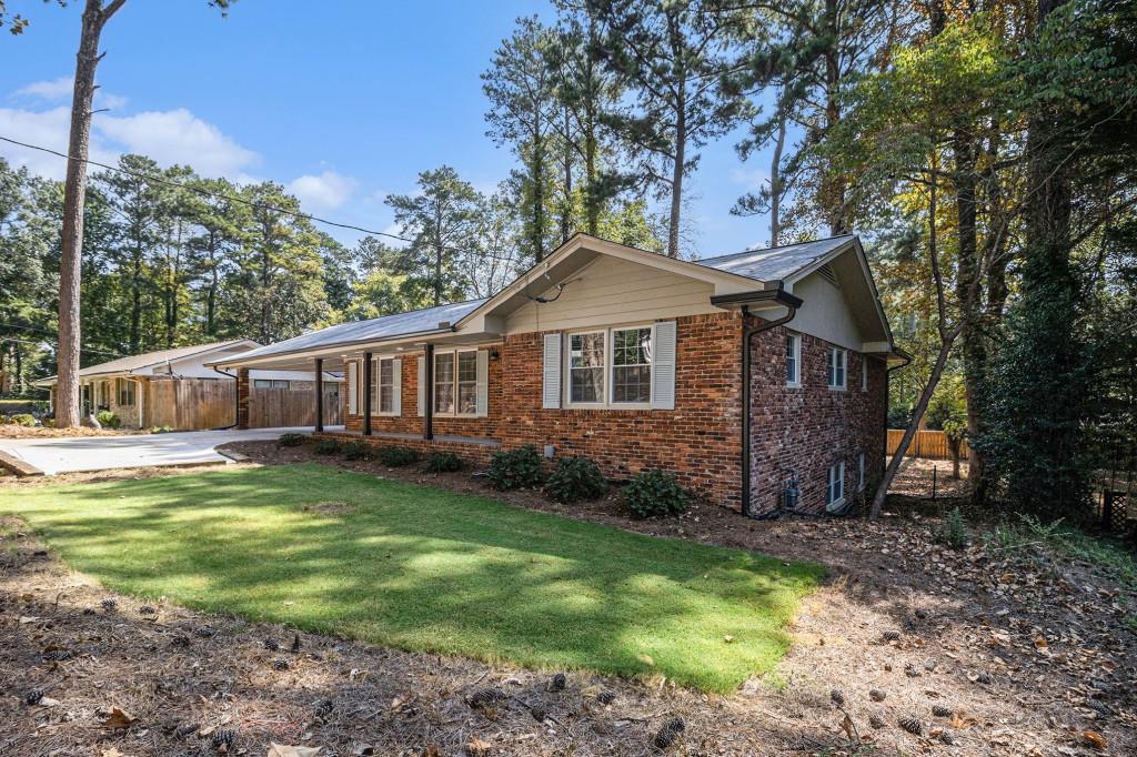 Welcome to a completely updated home in Dunwoody's desirable Cherry Hill neighborhood. This move-in ready ranch offers over 2,000 sq ft of stylish living on a spacious 0.42-acre lot. The home has been transformed with a focus on modern living and convenience. Enjoy a renovated kitchen, updated baths, and refinished hardwood floors throughout. Major systems have been replaced, including new windows, a new HVAC system, and a new water heater, providing comfort and peace of mind. The open layout features a cozy wood-burning fireplace, while a newly stained 25x16 deck is perfect for outdoor gatherings. More improvements include a finished basement, a main-level laundry room, new gutters, and upgraded closets for better storage. A dedicated workshop and ample parking add to the home's functionality. The property sits on a spacious yard with mature, upgraded landscaping. This is a rare opportunity to own a home that feels new inside and out. Walk to Brookrun Park and enjoy quick access to I-285, Dunwoody Village, Perimeter Mall, The Forum at Peachtree Corners, and top-rated schools.