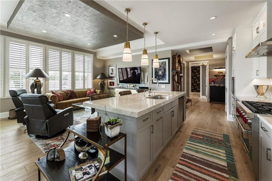 Experience elevated living in the heart of downtown Alpharetta with this stunning, upgraded penthouse condominium just step from the city's top restaurants, boutiques, and entertainment. This beautifully appointed home features immaculate hardwood floors, plantation shutters, and upgraded luxury lighting throughout. The gourmet kitchen is a chef's dream, boasting a large island, custom cabinetry, Taj Mahal quartzite countertops, and high-end finishes. The oversized primary suite offers a serene retreat with space for a home office, a spa-like bath with designer touches, and a custom walk-in closet. A light-filled guest bedroom includes an ensuite bath, while a third bedroom--currently used an office--also pairs with a full bath, making it perfect for guests or flexible living. Enjoy the outdoors year-round from your private, covered terrace with cozy outdoor fireplace. Additional highlights include a large, dedicated storage unit and access to the building's upscale amenities, including a clubhouse, grilling station, and outdoor dining area. Residents enjoy a secure, low-maintenance lifestyle in one of Alpharetta's most desirable locations. This is more than a home--it's a lifestyle.