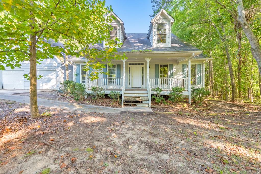 Welcome home! Nestled on a quiet, private lot on over 5 acres in the Creekside Manor North community, this 3 bedroom, 2.5 bathroom home is full of potential and ready for your personal touch. A large covered rocking chair front porch welcomes you in, leading to a traditional layout with a separate dining room and a spacious kitchen featuring white cabinets, ample counter space, a center island with seating, and a sunny breakfast room. The fireside family room boasts vaulted ceilings and great natural light. The oversized primary suite offers vaulted ceilings, an updated ensuite bathroom with a sleek glass shower and double vanities, and a walk-in closet. Two generously sized secondary bedrooms share a full bath, and a half bathroom and laundry closet complete the main level. Upstairs, a large bonus room provides flexible space for an office, playroom, or fourth bedroom. Outside, enjoy the covered back deck overlooking the serene backyard, in-ground pool, and open green space. With an attached 2-car garage and a great location close to Downtown Douglasville, I-20, the airport, and plenty of shopping and dining—this home is a rare opportunity to create something truly special. No HOA!