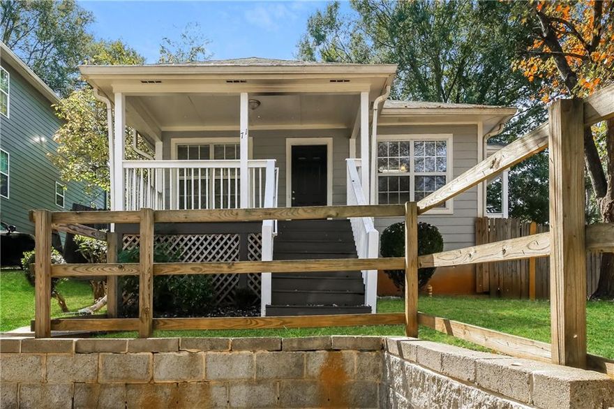 Welcome to 71 Thayer Avenue SE in Lithonia, a single-story ranch built in 2001, offering 1,066 square feet of comfortable living space on a 0.18-acre corner lot. Enter into a bright living area graced with hardwood floors that flow seamlessly into a dining space enhanced by luxury vinyl. Fresh paint sets a modern tone as you move through the layout, where three bedrooms and two full baths deliver both functionality and ease. The kitchen displays stained cabinetry, laminate counters, and efficient flow toward the dining and living areas. The primary suite provides a private escape with an attached full bath, and walk-in closets add convenience. Outside, a front porch presents an inviting transition to the outdoors, while a fully fenced backyard with a wood outbuilding offers privacy and flexibility for storage, hobbies, or relaxation. Parking is handled via a driveway, and there is no HOA. Nestled within Historic South Atlanta and close to downtown, public transit, parks, and schools, this home blends city access with neighborhood peace.