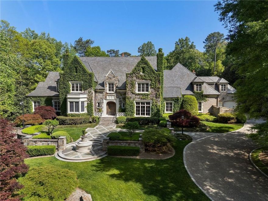 Set on an expansive three-acre private estate in Atlanta's exclusive Paces Ferry neighborhood in Buckhead, this stunning custom stone English manor, designed by renowned architect William T. Baker and built by custom builder McGarity.Timeless elegance combined with modern sophistication. Exceptional value at this price and available now. This gated property set way back from the street with a sweeping drive leading to a meticulously designed motor court and four-car garage, ensuring plenty of parking options. The interiors finishes are a testament to exceptional craftsmanship, beginning with the grand two-story foyer, where oak paneling and marble floors set a luxurious tone. To the left, an elegant study with fireplace provides a refined retreat. To the right, is a formal living room with fireplace or seating area. The heart of the home is the chefs kitchen and separate catering prep kitchen. Featuring two expansive islands clad in marble, professional-grade appliances, and dual pantries - including a butlers pantry - designed to make entertaining seamless. This space flows effortlessly into the spacious family room, complete with soaring vaulted ceilings, a cozy fireplace, and an adjacent sunroom that invites natural light and views of the lush surroundings. A standout feature is the glass conservatory, imported from England, offering a serene space to enjoy the gardens year-round. The main-level primary suite is a private sanctuary, complete with a sitting area, fireplace and overlooking the pool.  Two separate generously sized dressing rooms. Upstairs, four additional bedrooms, each with en suite bathrooms, provide ample accommodations for family and guests. A versatile bonus room and an elevator that accesses all three levels add to the homes functionality. Whole house generator, upgraded integrated lighting and security system. The terrace level is designed for recreation and relaxation, boasting a billiards area, full bar, wine cellar, fitness center, sauna, and a state-of-the-art movie theater. Outside, the grounds, envisioned by famed landscape architect John Howard, offer a resort-like experience. Enjoy lush, professionally curated gardens with over 70 specimen Japanese Maples, a sparkling pool with a hot tub, an open-air summer pavilion, and a dedicated play area with playhouse.  This 3 acre estate offers unparalleled access to Buckhead premier shopping, dining, and some of the cities top public and private schools. Own  a legacy property blending classic sophistication with modern amenities in one of Atlanta's most sought-after locations.