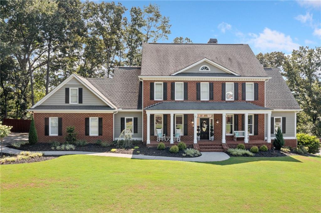 Nestled on a private half-acre lot in The Waterford, this brick-front home welcomes you with a gorgeous front porch—perfect for morning coffee or evening relaxation—leading into a formal entryway with a living room (ideal for a home office) and a separate dining room. The space flows into a dramatic two-story family room featuring a 20-foot wall of windows, built-in entertainment center, and a charming brick fireplace. The crisp white kitchen boasts a large island with gas cooktop, walk-in pantry, and breakfast room, plus a main-level laundry for added convenience. The oversized owner’s suite on this level offers direct backyard access, an expansive walk-in closet, and a luxurious bath complete with a jetted tub and separate shower.
Upstairs, three additional bedrooms and two full baths provide ample space for family or guests, while the fully finished daylight basement—with its own entrance—includes a fifth bedroom, full bath, and plenty of flexible space for a media, gym, or workspace area.
Outside, unwind in your fully fenced backyard with new retaining walls, stone stairs, and fresh landscaping in this quiet cul-de-sac setting. Residents of The Waterford enjoy resort-style amenities: clubhouse, Olympic-size pool, tennis & pickleball courts, playground, party shelter, and cabana. Just across the street, Dellinger Park offers miles of running trails, city pool, courts, picnic pavilions, and a scenic pond. Zoned for Cartersville City Schools and minutes from downtown shopping, dining, and entertainment, 25 Westchester Drive perfectly blends classic craftsmanship, modern updates, and an outstanding community lifestyle.