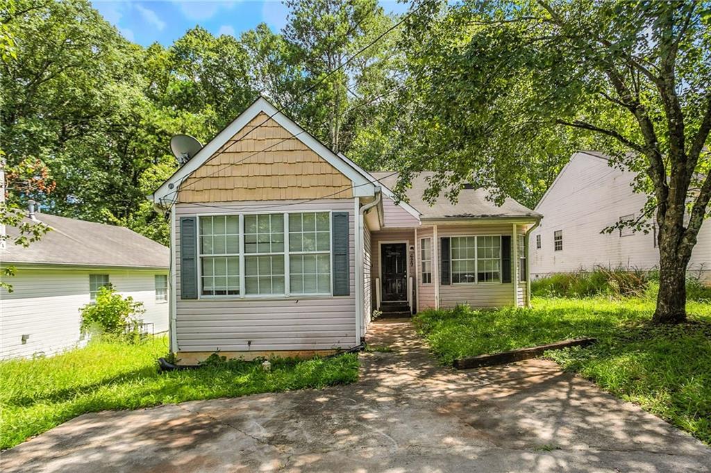 Spacious 4-bedroom, 2-bath ranch in a quiet Southeast Atlanta neighborhood. The layout includes a large living room with fireplace, separate dining area, and a functional kitchen with plenty of cabinet space. All bedrooms are on one level, offering flexibility for guests or home office use. The lot is level with a private driveway and easy-to-maintain yard. Located with quick access to I-75, the airport, and downtown.