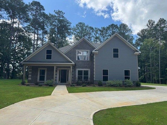 : This new construction home features 4 bedrooms, 3 and a half baths, and a two-car garage. On the main level is a formal dining room, a twostory family room, a laundry room, a kitchen with granite countertops, hardwood floors, stainless steel appliances, an island, and a pantry, and the primary suite
with a sitting room. The second floor features three secondary bedrooms and two secondary baths