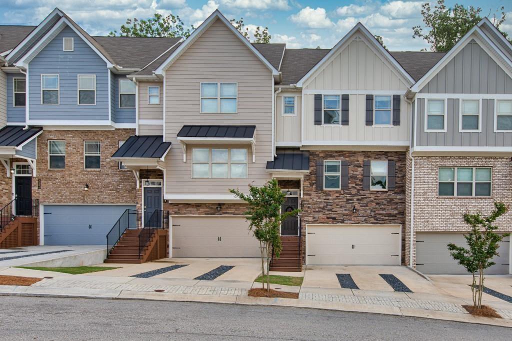 For Lease – Spacious 3BR/3.5BA Townhome with 2-Car Garage & Finished Basement!
This beautifully maintained townhouse, built in 2019, features an open-concept main level with a spacious family room, eat-in kitchen with stone countertops, breakfast bar, and a private back deck with serene wooded views. A convenient half bath completes the main floor.
Upstairs offers two oversized master suites with tray ceilings, large vanities, walk-in closets, and en-suite baths featuring separate tubs and stand-up showers – ideal for families or roommates.
The finished terrace level includes a third bedroom with full bath and closet—perfect for guests or a home office. Washer and dryer included.
Landlord covers: HOA dues, landscaping, termite service and trash.
Tenant responsible for: Water and electric (no gas).
Outstanding location—walk to the high school, less than a mile to I-985 and UNG Gainesville campus. Dog park located in the neighborhood. Just minutes from Lake Lanier, downtown Flowery Branch & Gainesville, local nature centers, walking trails, and plenty of shopping and dining options.
Don't miss this rare rental opportunity in a prime area!