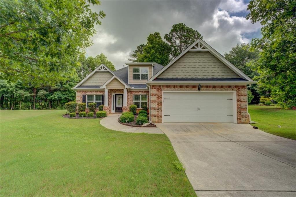 Perfect ranch home in popular Covington Place overlooking the eighth hole of Ashton Hills Golf Club. This easy living home has fresh paint and features a well-thought-out, open floor plan on the main level with a kitchen that would delight any chef, tons of counter and cabinet space, and a large breakfast bar perfect for casual meals or entertaining. The kitchen flows seamlessly into the spacious family room, complete with a cozy fireplace and large windows that fill the space with natural light and offer serene views of the golf course. The formal dining room is ideal for hosting dinner parties or holiday gatherings. The primary suite is a true retreat, featuring a tray ceiling, walk-in closet, and a luxurious en-suite bath with double vanities, soaking tub, and separate shower. Two additional bedrooms on the main level share a well-appointed full bath, while a fourth bedroom upstairs offers the perfect flex space for a home office, gym, or guest room. Enjoy morning coffee or evening cocktails on the back patio as you take in the beautifully manicured greens and peaceful surroundings. Located in a sidewalk-lined community with access to tennis and swimming, and a short golf cart ride from historic downtown Covington's shops, dining, and entertainment, this home combines comfort, convenience, and charm. Don't miss your chance to live the golf course lifestyle!