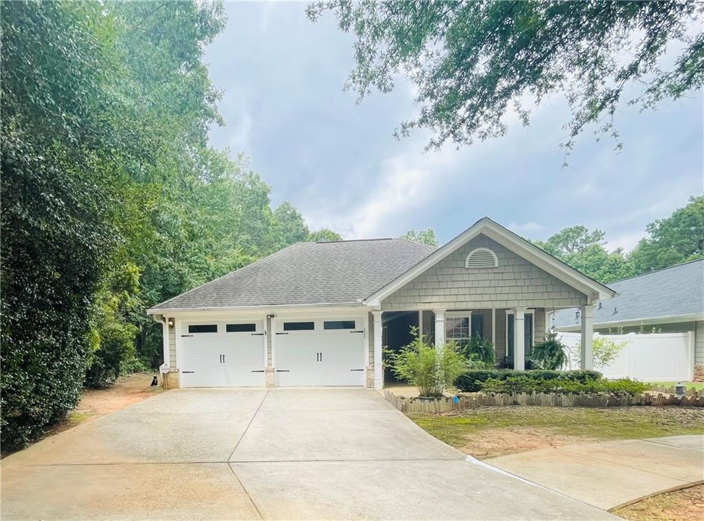 Located in Heron Bay Golf Country Club, south Atlanta's premiere resort-style community, this charming craftsman style home is situated on the course's 9th fairway! This very unique and highly sought after plan features three bedrooms and three baths, with the owner's ensuite and a second bedroom and bath being located in the main area of the home from the front porch, you'll enter into the private courtyard via a wrought iron gate, providing a unique and intriguing feature to the elevation. To your left is the ever-popular CASITA featuring a bedroom w/private bath overlooking the courtyard. This incredible feature offers lots of options, as the casita is private from the rest of the house and can be used as a teen/in-law suite, an office, a man cave, or for guests who come for an extended stay! So many options for this multi-functional area! The oversized Chattahoochee pebble stone patio in the private courtyard offers an inviting setting for private gatherings, or simply for enjoying the serenity and privacy of the outdoors in your own space! There are also stone walkways in the courtyard so that you can easily access the front or back yards. Just a few steps ahead, you will enter into the foyer of the main home, featuring a spacious family room/dining room with electric fireplace that opens up into the tiled sunroom with lots of windows and terrific views of the beautiful golf course! Off the sunroom, there is also a patio. The kitchen has granite countertops and stainless appliances (gas stove), a raised gathering bar and a breakfast nook. Pantry. In addition to the tiled sunroom, there is tile in all wet areas, including bathrooms, kitchen, and laundry room. This home is designed to provide privacy for all when retiring. The oversized owner's suite spans the left side of the house, with the sitting area/office nook overlooking the soothing views of the golf course. There's also a French door from the bedroom to the private courtyard. Then, on the other side of the kitchen, there's the secondary bedroom and bath. In addition to all that this home has to offer, the community amenities are unparalleled. The resort-style community offers an aquatic center with splash pool and dual slides, mushroom sprinklers, a zero entry pool for the kiddies, and a junior Olympic size swimming pool just past the front entrance to the community the convenience and enjoyment of our residents, there's also a smaller, intimate pool more centrally located in the community. Organized teams with plenty of tennis and pickleball courts. There's also a Dog Park and a Sports Park, in addition to nature trails throughout the community. Our premiere amenity is quite probably the Lakeview Park and pavilion, situated on the 1100 acre Cole Reservoir - perfect for kayaks, canoes, and non-gas powered watercraft. An added feature is that the Cottages & Villas communities include mowing, edging, trimming, exterior sprinkler, trash, and termite bond, not to forget the private clubhouse where there are events for the C&V residents that are in addition to those sponsored by the Master Association. There's so much to choose from - and it's all included in your assessments.