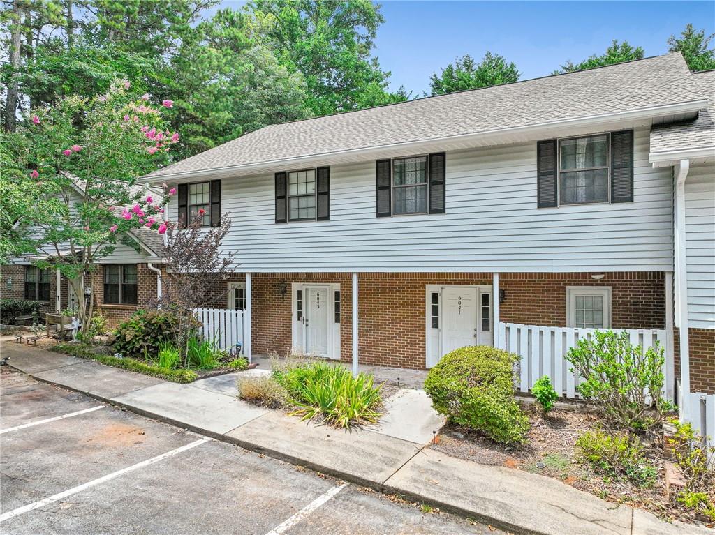 WELCOME HOME!! 3 bed 2.5 bath two story townhome in Norcross accessible to everything!! As you walk into the light filled foyer you have the half bath just for guests ad a hallway closet! Keep walking into the open floor plan living room with brick fireplace, dining room space, and UPDATED kitchen Stainless steel countertops, glass tile backsplash, upgraded GAS STOVE & Oven 5 burner you just don't see that in these units ever - ALL APPLIANCES STAY WITH THE HOME! Living space overlooks the sunroom with utility closet storage and green space behind the home! Just off the kitchen is a hallway to the laundry room and mudroom with second entry making it so easy to bring your groceries inside! As you head upstairs you'll notice the two story stair well with crystal chandelier. Master suite has its own full bathroom and an entire wall of closet space! Two other great sized bedrooms with hallway full bathroom there is space for everyone! ENTIRE INTERIOR has been painted & new LVP flooring throughout! This place is truly turn key & one year home warranty is provided for ease of mind! Wintergreen community includes Pool and Dog Park! TWO PARKING SPOTS Close to I-85 Buford Highway, super H mart, multiple Jaliscos, and coveted Gwinnett County parks *Best Friend Park is my fav* Ask me how we can get you up to $3,000 towards closing costs!