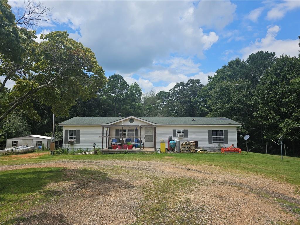 Welcome to 267 Williams Rd in Tallapoosa, GA — a private 11.71-acre retreat featuring a 3-bedroom, 2-bath manufactured home with over 1,400 sq ft of comfortable living space. This well-maintained home offers a split-bedroom floor plan with a master suite on the main level, a spacious living area with a wood-burning fireplace, and a cozy layout perfect for peaceful country living. The property boasts a mix of wooded and open land, ideal for homesteading, recreation, or simply escaping the hustle and bustle. Additional highlights include propane and wood heating options, ceiling fans, window units for cooling, and a large 30x40 pole barn. No HOA, low annual taxes, and located at the end of a quiet road for maximum seclusion. A spring-fed creek adds even more charm to this serene rural property. Schedule your private showing today!