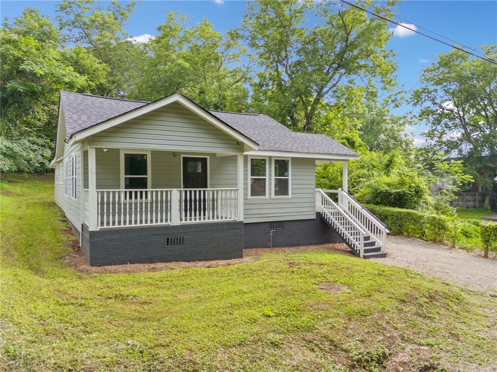 A stunningly remodeled 3 bedroom, 2 bath one level home in the heart of Rome, beautifully transformed inside and out, and ready for its new owner. Upgrades include, but are not limited to: a new roof, HVAC system, water heater, stainless steel kitchen appliances, luxury vinyl flooring, new cabinetry and vanities, Hardie Plank siding, upgraded insulation, Energy Star-rated windows, and a moisture barrier in the crawl space. This home features two charming porches—one private porch exclusively for the front bedroom, and another side porch that leads directly into the living room. A spacious deck extends into the private backyard, offering the perfect setting for entertaining, relaxing, or simply enjoying the outdoors. With so many inviting outdoor spaces, the potential for open-air living is endless. Opportunities like this don’t come often—book your showing today. Interior photos will be uploaded on 6/21. No showings until Sunday 6/22