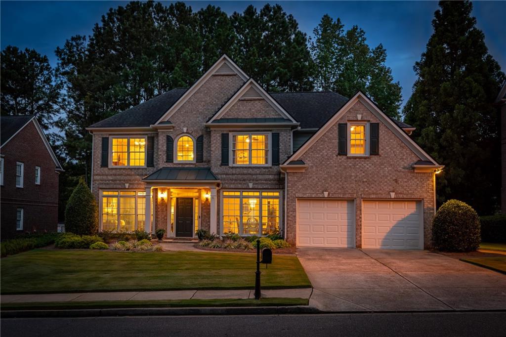 ENJOY GOLF COURSE VIEWS FROM YOUR SCREENED IN PORCH! LOCATED ON THE 4TH HOLE, THIS HOME FEATURES A WELL-EQUIPPED KITCHEN, OVERSIZED PRIMARY SUITE, AND LUSH LANDSCAPING. Throughout the home you'll find a neutral color palette, hardwood flooring, and updated lighting. Soaring ceilings in the family room allow for plenty of natural light and a floor-to-ceiling stone fireplace. The kitchen has newer white cabinetry, stone countertops, newer appliances and a large island. A guest suite on the main level offers pretty views of the backyard and golf course as well as a full bathroom. Rounding out the main floor is a formal dining room and a formal living room that could easily be used as an office. Upstairs are four large bedrooms including the primary suite. The suite's high ceilings, separate sitting area, generously sized closet with custom organizers, and bathroom with new quartz countertops make it the perfect place to retreat and unwind at the end of a busy day. A well-manicured backyard features mature landscaping with lighting, WIFI-enabled irrigation, wrought-iron fencing, a pond with a waterfall, and a stone patio covered by a pergola. Unlike many homes in the area, this home features a flat lot with plenty of room for playing or gardening. This home has been well-maintained and includes a whole-home surge protector and updated HVAC that includes a separate zone for the primary suite. This is an excellent opportunity to take advantage of the country club lifestyle Windermere offers at a great value.
