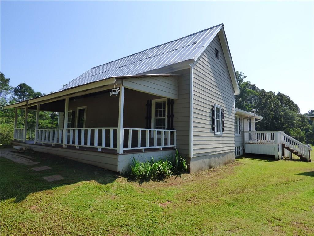 Quiet country setting-Circa 1900 restored farmhouse on 3.39 acres ready for your small farm or garden. Home has 3 large bedrooms and 2 full baths. Original woodwork and trim make this home feel as if you stepped back in time, yet updated for today's modern conveniences with updated kitchen, wood laminate flooring throughout, large open rooms and lots of light throughout. There is a large attic upstairs with potential to add on a master suite or bonus room. There is loads of potential in this charming home.