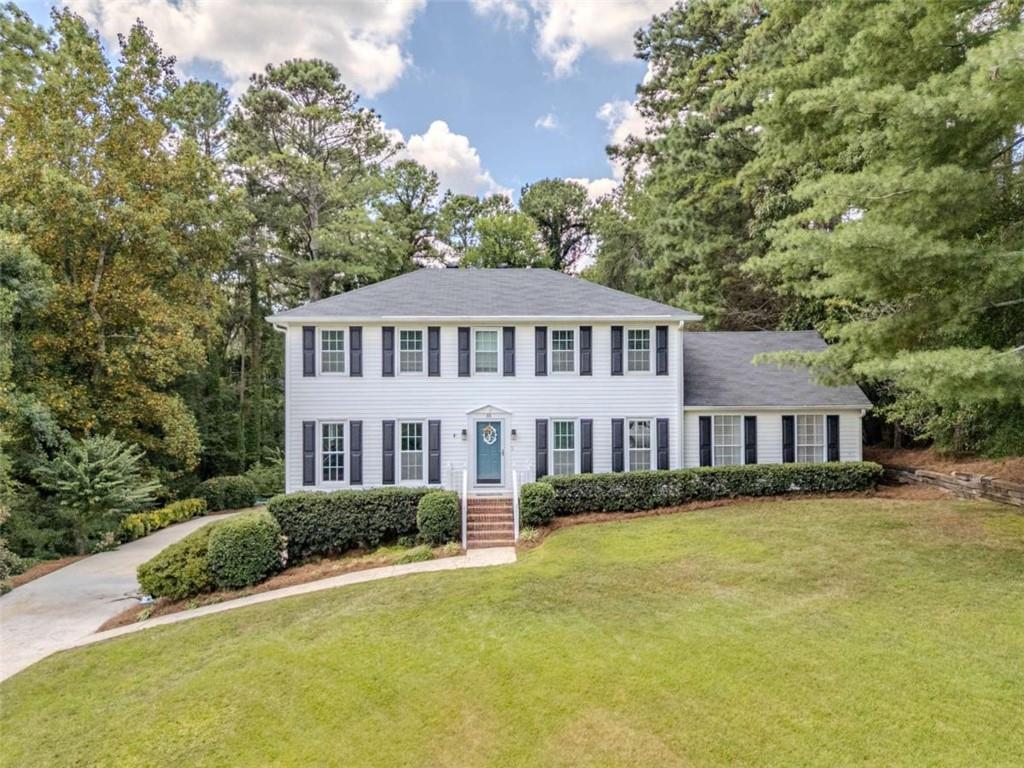 Wonderful large family home in Woodfin Estates! New roof, new tankless water heater, and an encapsulated crawlspace! On the main floor is a living room with floor to ceiling windows and a fireplace, office, kitchen and HUGE den with built-ins adjacent to a spacious sunroom. Upstairs are two bedrooms and a full bath in the hallway. The master has an en-suite bath and a large closet/office flex space. The basement is used as an additional guest bedroom with a closet and the laundry. The deck out back is the perfect place for entertaining. Raised beds and a small water feature (add your own fish!) make the backyard very inviting!
