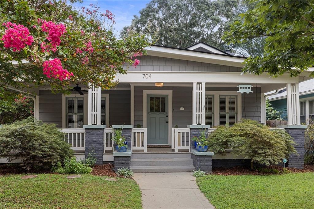 Welcome to this stunning California Craftsman bungalow in Ormewood Park! This circa 1930's gem was fully renovated in 2015 and lovingly maintained since. This wonderful corner lot location showcases classic Craftsman charm with a welcoming rocking chair front porch. The thoughtful interior boasts an open-concept layout with 4 bedrooms and 2.5 bathrooms. Step through the front door to find a lovely formal living room with an original, decorative fireplace, plus an adjacent bedroom/office space and large closet. Continue on to find a sun-filled dining room with another original, decorative fireplace. Past the dining room you will find a showstopper of a chef's kitchen featuring designer cabinetry, quartz counters, stainless appliances, wine fridge, and an oversized breakfast bar. The open concept kitchen flows to a spacious family room with a gas-burning fireplace that opens onto a lovely back deck. The owner's suite, complete with an en-suite bath boasting double vanity, quartz counters, frameless shower, and a large custom closet can be found off of the kitchen. Two additional sunny bedrooms offer custom closets and a large jack-n-jill bathroom with oversized double sink, quartz counter, and classic subway tile. Out back, off the deck you will find a two car parking pad with an electric gate and a shed ready to house tools, lawnmowers, bikes, strollers, etc. From this location, your walkability options are nearly endless. Just steps from the Beltline Southside Trail - walk, bike, or run to popular hotspots including Ormewood Square, East Atlanta Village, Glenwood Park, Grant Park, The Beacon, and Madison Yards.
