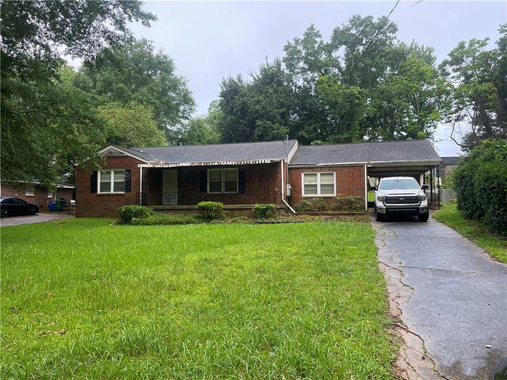 Brick Ranch with Endless Potential! This solid three-bedroom, two-bath single-family home is ready for your personal touch! Step onto the rocking chair front porch—perfect for morning coffee or evening relaxation. Inside, you'll find original tile in the bathrooms, adding a touch of vintage charm. The convenient carport provides covered parking or space for a workshop. Whether you're looking to renovate or invest this classic brick beauty offers a strong foundation and tons of potential in a desirable location.