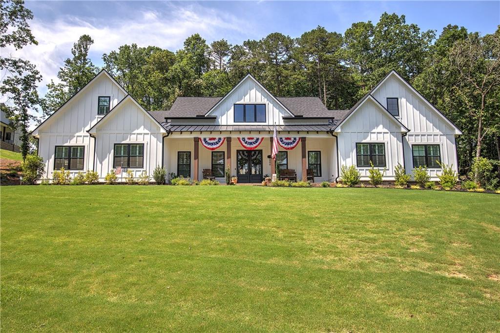 Welcome to this exquisite Tallulah farmhouse, the largest floorplan in The Tate Reserve, thoughtfully built in 2024 and nestled on a peaceful 1.5-acre lot. This spacious home effortlessly blends timeless farmhouse charm with modern elegance, offering five generous bedrooms and four and a half beautifully appointed bathrooms. Step inside to an open and airy floor plan flooded with natural light, designed for both comfortable family living and effortless entertaining. The heart of the home, a gorgeous living room, invites you to unwind beneath an elegant coffered ceiling and admire the custom built-in cabinets that perfectly blend style and function. The chef-inspired kitchen boasts pristine white cabinetry and a massive walk-in pantry, providing ample storage and workspace for culinary adventures. Just beyond, a large back patio with a built-in grilling station beckons for memorable outdoor gatherings, whether casual barbecues or festive celebrations. Two dedicated home offices offer quiet, flexible spaces for remote work, study, or creative pursuits. The spacious three-car garage adds convenience and plenty of room for vehicles and storage. Set in the highly sought-after Tate Reserve neighborhood, this home offers serene country living with easy access to modern amenities. With thoughtful design details and an expansive lot, this farmhouse is truly a one-of-a-kind opportunity to embrace the best of Southern living.
