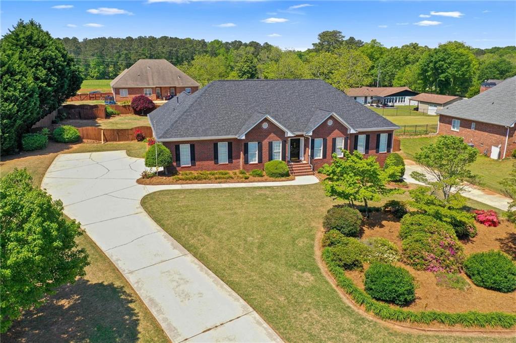 INTEREST RATES MATTER APPROVED LENDER OFFERING 1% BUY DOWN ON THIS IMMACULATE One Owner ALL Brick Ranch Home! Amazing Open Floor! Home has a huge trey ceiling great room w/fireplace w/formal living room area and Formal Dining Room! The Gourmet kitchen has loads of cabinets, solid surface countertops, breakfast bar & eat-in area plus all the appliances! Split Bedroom design, with an oversized Double trey Owner's Suite and en-suite private bath w/large soaking tub, separate tiled shower & large walk-in closet! The secondary bedrooms on the other side of the home are both large & one has walk in closet! Real Hardwood floors throughout the home with the exception of the Owners Suite and kitchen. As you enter from the 2-car garage you have a nice 1/2 bath, big laundry room and just off the great room is a heated & cooled sunroom that overlooks a beautifully landscaped yard that's surrounded by privacy fencing! Downstairs you have a large basement w/bedroom, full bath, workshop, plenty of expansion room to make your own! Plus, you will love the separate paved Drive to the basement area! Beautiful landscaping in the front & back and the back yard has a privacy fence! This is a quiet one street neighborhood with NO Homeowners Association! Quality built Charles Gower home in the Union Grove & Hickory Flat School District! Call for the LBR Team or your agent for your personal Tour! **1-Year Rate Buydown Available! Our preferred lender is offering a 1-year temporary buydown for this property. This program will lower your monthly payments by a full percentage point for the first year. Ask us for all the details! **
