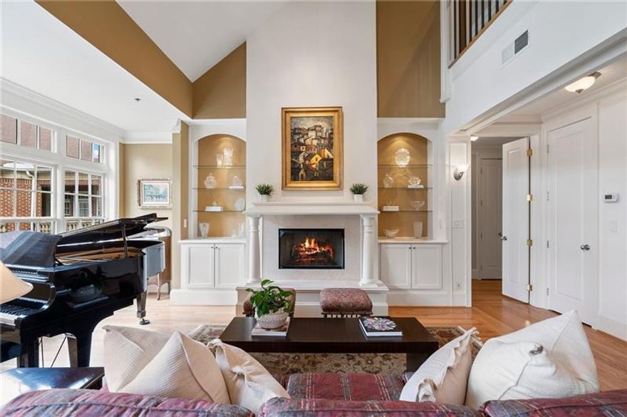 Experience refined luxury in this rare two-story, three-bedroom penthouse at Midtown’s premier boutique building, Cotting Court. Offered for the first time on the resale market, this residence lives like a single-family home, featuring soaring ceilings, new hardwood floors, and stunning natural light throughout. The main level includes a gracious open living and dining area with a gas fireplace and illuminated shelving, a spacious primary suite, and a guest suite or den with a private bath. Upstairs, a richly paneled office and sitting area with custom built-ins complement an additional ensuite guest bedroom. Elegant millwork, abundant storage, two premium parking spaces, and a private storage room enhance everyday comfort. Enjoy full-service amenities including a 24-hour concierge, fitness center, and pool. Ideally located in the heart of Midtown—just moments from Piedmont Park, the BeltLine, Fox Theatre, and Atlanta’s top dining and cultural destinations—this exceptional penthouse offers the perfect blend of sophistication and convenience.