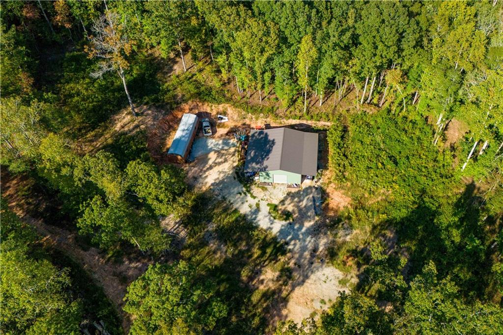 Three tracts of beautiful wooded property with a total of 40.81 acres. One deer plot, 2 creeks (the larger creek feeds into Lake Seaton), a 30 X 40 barn with concrete floor, 2 storage sheds, a garden area, several areas cleared for building, a large rock fire pit near the small creek. Lot of natural ferns around the creeks. The back tract is natural and untouched. Currently zoned agricultural and in a land covenant for property tax break. Perc test has been completed on the 2 front tracts. Easement access to all 3 tracts.
