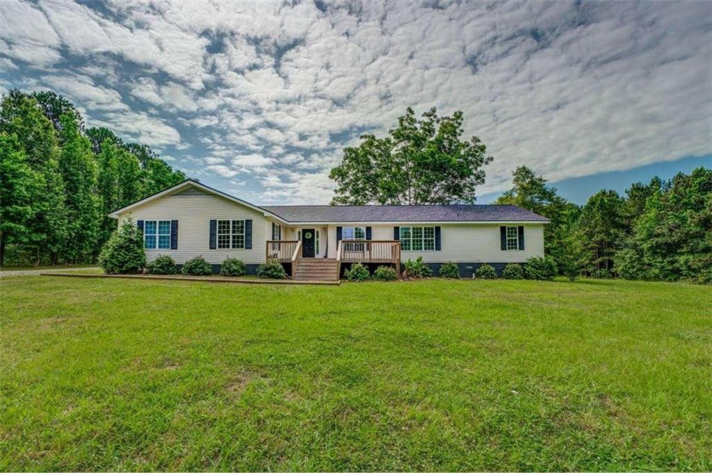 Gorgeous 5 acre property with a stunning 5 bedroom 3 and a half bath farmhouse style home! The home is situated perfectly and tucked back away from the road. Enjoy the large front porch as you watch the sunrise with your coffee. Perfect back yard for the kids or animals to roam around. Property has a shed, a chicken coop, and 3 porches. Home had all carpet replaced September 2022, septic pumped at the same time and a new roof April 2023. Excellent layout featuring split bedroom ranch plan 3/2 on one side with a living room and 2/1.5 on the other side with its own living room. Could easily be used as a mother in law suite. This home has endless possibilities and just 10 minutes from downtown Monticello.