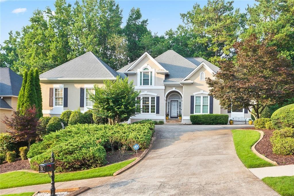 Price improvement in Towne Lake Hills East! Exceptional 5 bedroom 4 and 1/2 bath Featuring Master on Main and three beautifully finished levels! Enter the welcoming front courtyard driveway and you are greeted by the Flagstone front porch and the beautiful leaded glass front Door. The Tray Ceiling foyer is flanked by the open concept dining room with recessed accent lighting on the left and the Sitting room/office on the right! the gracious two story fireside great room reflects the style and function of this amazing residence. Light filled, spacious and peaceful describe the interior, complete with fresh paint, rich hardwoods and lush carpeting. This custom floor plan offers an elegant master suite on the main level with sumptuous bath and dual walk-in closets, and also two additional large main level bedrooms on the opposite side of the house that share a Jack and Jill full bath. The Chef's Kitchen includes gleaming white cabinetry, granite counters, stainless appliances, custom lighting, walk- in pantry with views to breakfast room and Great room.
Completing the main level are the half bath and laundry room with Washer/Dryer included in the sale of the property. The upper level has two large bedrooms that share a bathroom each bedroom has it's own vanity! The wonderful daylight basement includes both finished and unfinished spaces. Finished rooms include Media/ Gathering room, Billiard/Rec room, Pool table and all accessories included, full bath, flex bedroom/office room and kitchenette. Ideal for entertaining or teen/in-law suite. Unfinished area welcomes your completion with large rooms, or use for storage with high ceilings, and exterior entry door and full sized Boat door.
Completing this amazing residence is the main level pergola deck overlooking the very private wooded backyard, Irrigation system, security system, and the spacious two car garage. With resort style amenities, 18 Hole Championship Golf Course, and The Tavern restaurant, Great schools, and close to Shopping, services, restaurants, parks and express lanes, and, Hospitals and also a short drive to trendy downtown Woodstock, 5059 Winding Hills Lane is the perfect spot for exceptional family living and entertaining!