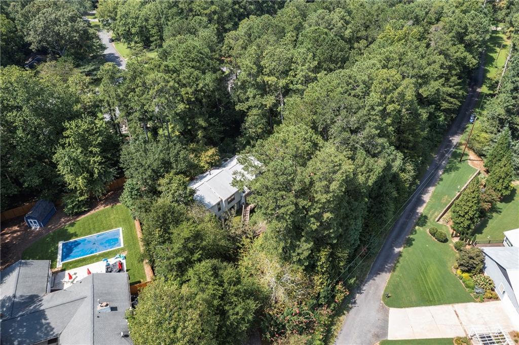 Set amid the beauty of Nature, this properties leafy surroundings welcome's all to it's serene charm. It is truly a private oasis. From the moment you arrive you will feel at home in this peaceful neighborhood. Friendly neighbors walk their dogs and chat as they go. This is a true community. There is a mix of mature adults and young families drawn to the area by excellent schools.
Appliances are top quality stainless steel. The stove has an electric cooktop and the oven can be a regular oven or that most dreamed of Convection for baking.
The Floors in the main level are beautiful gleaming Asian Rosewood. Kitchen has upgraded tile, exceptional counter tops and backsplash.
Lower level has a wet bar and a half bath, ideal for entertaining. The upper level hosts a hall bath serving 2 bedrooms. The Master is very roomy with a walk in closet and adjoining Master Bath. In house Vacuum.
Easy access to East Cobb shopping, dining & outdoor activities. Groceries nearby.