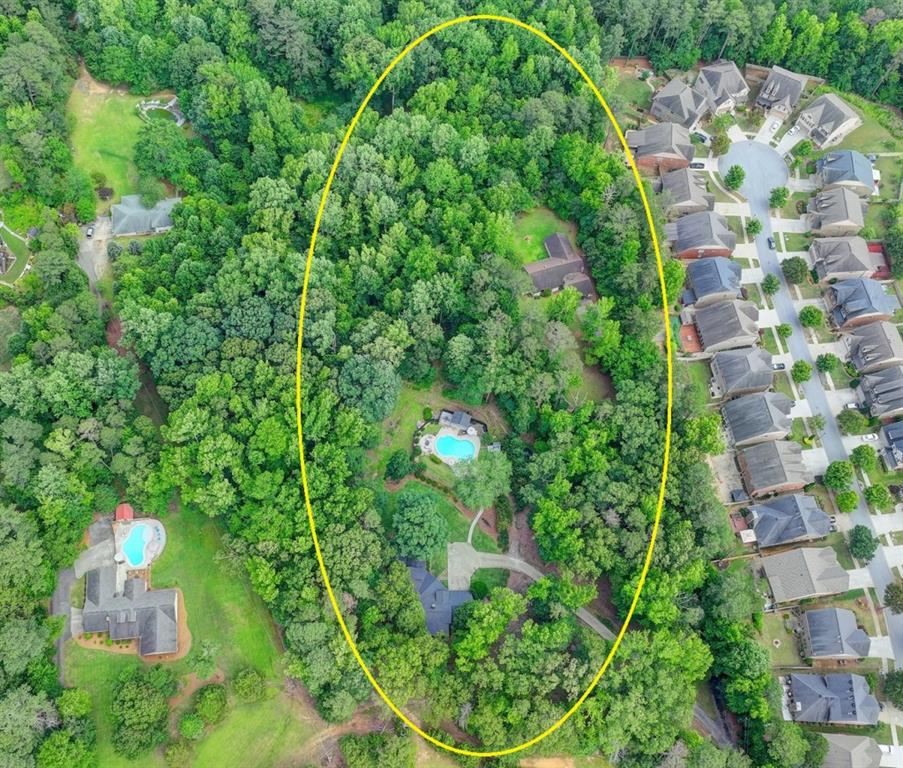 LOCATION, LOCATION!!! TWO (2) HOMES, WITH AN AMAZING POOL AREA AND CABANA, ON OVER 6 ACRES OF PROPERTY TO ENJOY OR EXPAND UPON! Properties like this one in Gwinnett do not come along very often, so be sure to schedule your appointment today! The first home features 4BR/3BA, open concept living, gorgeous kitchen, spacious family room, media room, multiple offices, modern finishes, many upgrades, and more. The second home is a 4BR/3BA ranch home with original finishes that can be easily modernized to your liking. Features for the second home are an open-concept living area, brick fireplace, spacious bedrooms, a private yard, and more. This dual home set up is perfect for multi-home compound living, rental units, recreational rental homes, guest homes or more. The pool area is fantastic and is convenient to both homes. Much of the acreage is currently unused and is perfect for adding other homes, outbuildings, recreation spaces, farming, etc. Minutes to shopping, dining, I-85, & Mall of GA! This sale is an assemblage of 2 parcels, addresses are 617/627 Rock Springs Rd. DO NOT MISS THIS RARE OPPORTUNITY TO HAVE ACREAGE IN GWINNETT. SCHEDULE AN APPOINTMENT TO TOUR!!