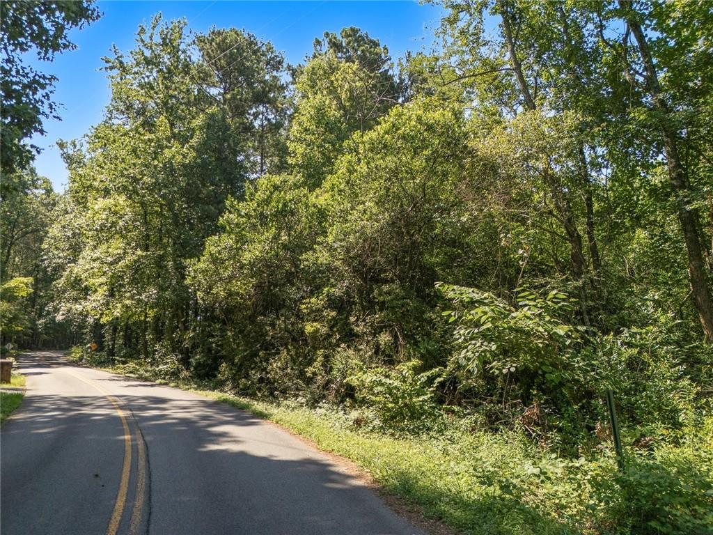 Discover a rare opportunity to create your custom dream home on this buildable 2.3-acre lot, offering a secluded and tranquil setting surrounded by established neighborhoods and upscale homes. Nestled just off Barrett Parkway and only minutes from the natural beauty of Kennesaw Mountain, this prime location combines the serenity of suburban living with unbeatable convenience. Enjoy nearby scenic walking trails, biking paths, and a variety of recreational amenities, as well as easy access to shopping and dining. This peaceful, private property is ready for your vision—an ideal canvas for your personal retreat.
