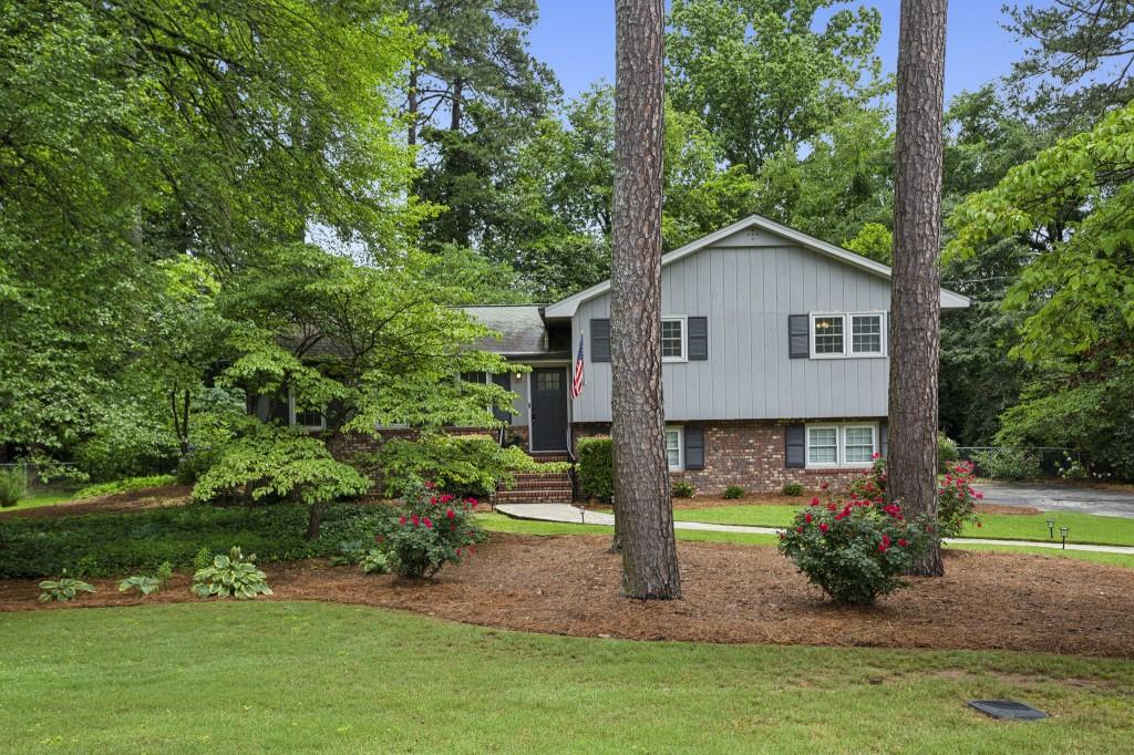 Tucked in the Highly Sought-After Stratford Community, This Move-In Ready Home Blends Modern Updates with Timeless Charm in a Prime Location Near The Battery, Marietta Square, and Smyrna Market Village. Step inside to discover a thoughtfully updated layout featuring a light-filled Family Room, stunning vaulted Den with exposed beams, and a cozy Brick Fireplace framed by expansive windows overlooking the private backyard. The updated Kitchen is a true showpiece, complete with timeless Gray Cabinetry, Granite Countertops, and a stylish Herringbone Backsplash perfectly open to the Breakfast Area and entertaining spaces. The spacious Dining Room easily accommodates gatherings, while the open-concept flow allows for both everyday comfort and special occasions. Retreat upstairs to a serene Primary Suite with a beautifully Renovated Ensuite Bath, featuring marble-style tile and a glass walk-in shower. Two additional bedrooms share an updated Hall Bath, ensuring comfort for everyone. Out back, enjoy a Fully Fenced Yard with lush landscaping, a large Deck for outdoor dining, a charming Patio Area, and even a Garden Shed creating your own private oasis. The mature trees and level lawn make this a standout for relaxing or play. Located minutes from top dining, shopping, and Braves games, this home checks all the boxes for lifestyle, location, and layout.