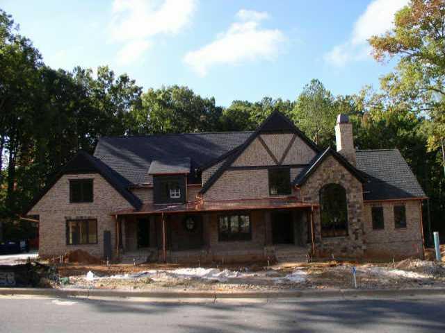 An inviting fromt porch beacons you inside this 5 bdrm brick manor home.Private wooded site. The open planof the warm kitchen, sunny breakfast room,& vaulted family room, create an easy flow for entertaining.