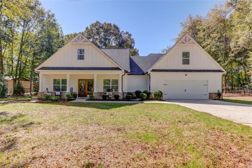 Built in 2021, this beautifully maintained 3-bedroom, 3.5-bath home offers over 2,400 square feet of thoughtfully designed living space on a private and wooded 1.35-acre lot. Enjoy peace and privacy while still being conveniently located near Social Circle, Covington, and Monroe.    Step inside to find an open-concept floor plan featuring spacious living and dining areas, high ceilings, and abundant natural light. The kitchen boasts modern finishes, ample cabinetry, and a center island perfect for entertaining. A cozy fireplace anchors the living room, making it the perfect place to unwind.    The large primary suite offers a spa-like bath and generous closet space. Additional bedrooms are well-sized and each includes its own bath or convenient access, ideal for family or guests.    Outside, enjoy the expansive lot surrounded by mature trees?offering space to garden, play, or relax in your private outdoor retreat. With a blend of modern construction, quality finishes, and serene surroundings, this home is truly move-in ready.    Don?t miss your chance to own a like-new home in a peaceful, sought-after location!