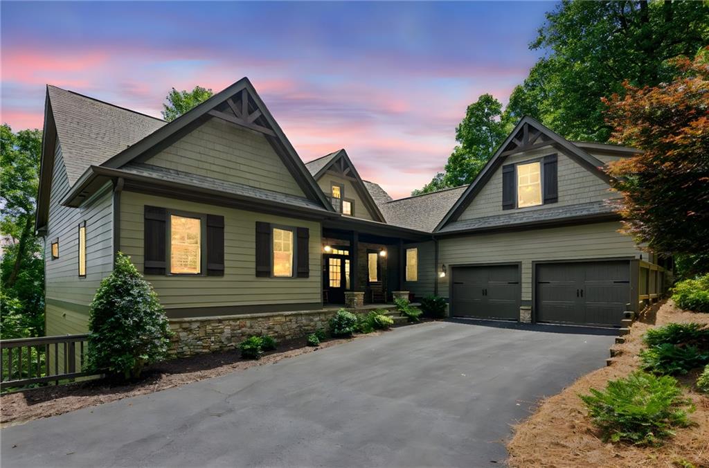REALLY BIG LONG-RANGE VIEWS! See the Atlanta Skyline from this beautiful home at the top of Big Canoe, located near the trail heads of some of the best hiking in the community. Live a casual lifestyle in this craftsman designed home and with the option to purchase it fully furnished, you can use it right away and start enjoying mountain living at its best. The home has beautiful vaulted wood ceilings and a massive stone fireplace in the open plan great room. The kitchen has a large island, plenty of cabinetry with easy access to the dining area. A large master suite on the main level provides one floor living. The large EZE Breeze screened porch has a rock fireplace to enjoy the spectacular views on those chilly mountain evenings. The lower level features a large recreation room and 2 bedrooms and 2 full baths plus a large viewing deck for your guests. The home has plenty of storage space and plenty of room to expand your home with 2 additional bedrooms and bathrooms and an elevator option. The home has 4-year young roof and a recent exterior paint job. ATTENTION VETERANS…the seller has an assumable 2.25% VA Loan on the home for a qualified veteran buyer.