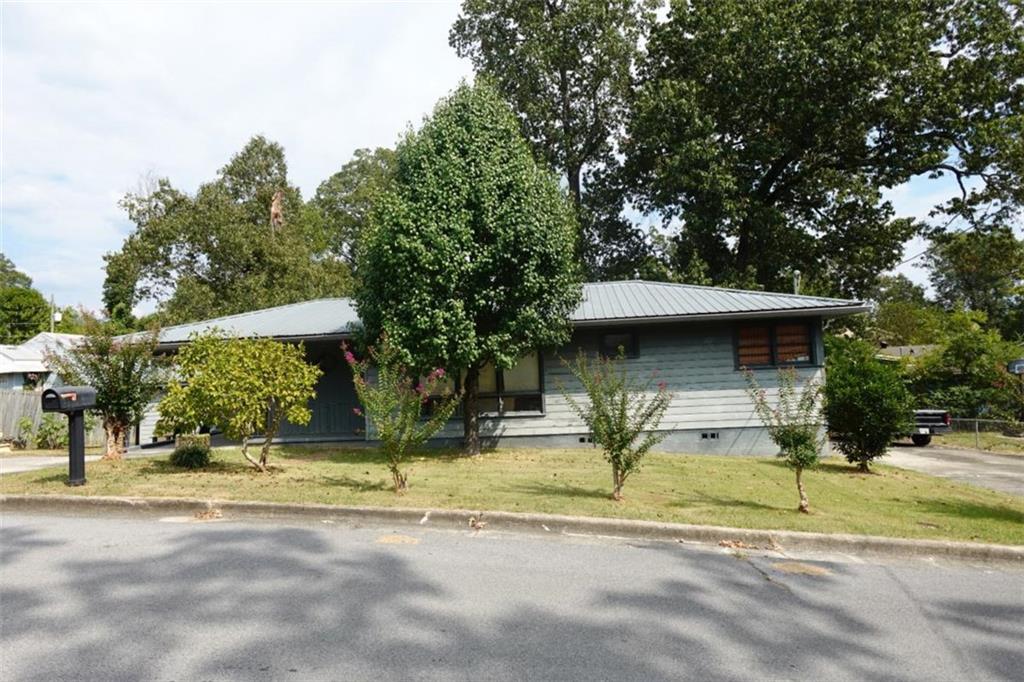 Charming 3BR/1.5BA ranch in West Rome, just off Shorter Ave. Natural light fills the living room through a large picture window, leading to an eat-in kitchen with side entry to the carport and separate laundry room. One bedroom can double as a den/office with access to the back deck. The hall bath offers a spacious vanity, tub/shower combo, and linen closet. Primary suite includes a private half bath. Fenced backyard with storage shed and deck, plus two driveways for ample parking. Convenient location near shopping, schools, and restaurants.