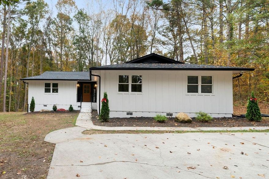 Look no further! Amazing opportunity to own a hidden gem in the desirable heart of West Cobb. This 4br 2bath open concept home has everything that you are looking for and more... As you enter the home, you will notice all the love and hard work that was put into this home to make it a place to call home! The kitchen features an oversized kitchen island with a built in, and one of a kind microwave, new stainless-steel appliances, beautiful white cabinets, quartz countertops and tile backsplash. The dining area has plenty of space to host a gathering. The inviting, large living room features, a fireplace and an oversized window to enjoy the view to the backyard and nature! The owner's suite offers an elegant accent wall, a huge walk-in closet, and a stunning bathroom with double vanities. The three secondary bedrooms are very commodious and with ample closet space and lots of natural light. The exterior of the home features, a deck to grill or to sit out and enjoy the peaceful feeling of the serene backyard, and with an acre of land... the possibilities of what you can do there are endless, like build a pool, gardening and so much more! Come tour this home and find out how close you are to the West Cobb Avenues, and all the shopping and dining around the area, you will be amazed!!