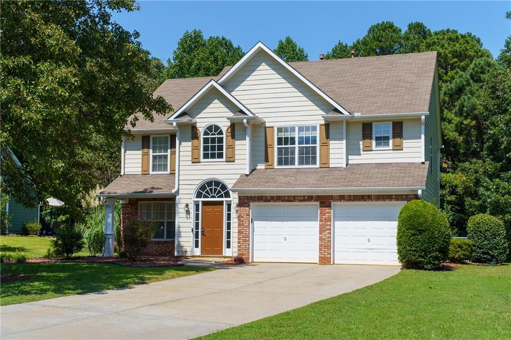 This spacious home sits on 0.67 acres with a beautifully maintained backyard featuring a stunning aboveground pool, expansive deck, and tree lined privacy with NO HOA. This classic home has loads of curb appeal with a huge front yard, extended side yard, and flat driveway leading up to the two car garage. You will enjoy easy to maintain landscaping with established shrubbery and a beautiful shade tree. The front porch is covered and offers a wonderful area to sit and unwind. Enter into the home to find hardwood flooring, high ceilings, and loads of natural light. The two story foyer welcomes you to the well designed layout with a spacious floor plan. Just off the foyer is a large formal dining room perfect for entertaining a crowd as it is just off the kitchen for your convenience. The beautifully updated kitchen features white cabinets, new stainless steel appliances, granite countertops, a center island with bar seating, and a pantry. Just between the kitchen and the formal dining room is a butler's pantry making entertaining a breeze! Or use this spot as a tucked away coffee or dry bar. Just off the kitchen is an open concept casual dining area with a fantastic view into the backyard. Continue on into the huge family room where you will find high ceilings, loads of natural light, and a cozy brick fireplace. Also located on the main is a half bath. Head upstairs to find an open loft perfect for creating a reading nook or play area. Your laundry is also conveniently located on the upper level with all bedrooms and the new washer & dryer are included! The oversized master bedroom features a trey ceiling, updated flooring, TWO walk in closets, and en suite bath with double vanity, soaking tub, and separate shower. The additional two bedrooms are also spacious and share the jack-n-jill style second bath with vanity, updated brass style fixtures, and a shower-tub combo. Enjoy the outdoors where you have an open air back patio just off the family room as well as a huge, tree lined backyard with loads of space for pets, a play area, or garden. Follow the stone pathway to your own personal oasis with a large above ground pool surrounded by a beautiful sundeck. This is such a fantastic spot to relax or entertain friends or family. The property also offers a shed for additional storage of gardening, landscaping, or pool supplies. Located in a highly sought after school district, this home is centrally located near local shopping and restaurants, as well as I-575. Within minutes you can find local coffee shops, Downtown Canton, parks, and the upcoming completed Downtown Holly Springs area that will bring additional community events such as shopping, concerts, and more! The property is in move-in ready condition, with excellent potential for future updates while already offering comfort, style, and functionality.