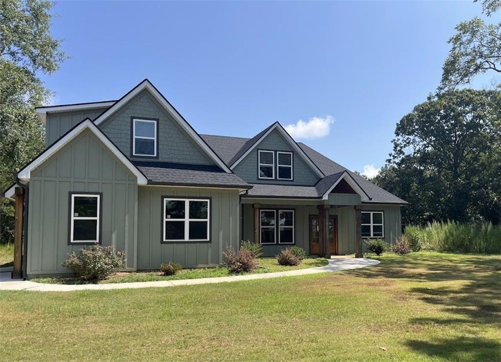 Practically new and perfectly designed! This stunning 5-bedroom, 3-bath home sits on 3.45 acres, offering the ideal blend of modern comfort and peaceful privacy. Built in 2022, the home features an open floor plan with gorgeous wood floors throughout and an inviting layout perfect for everyday living and entertaining.
The heart of the home is a chef’s dream kitchen—complete with a large island with seating, granite countertops, ample cabinet space, and a pot-filler faucet above the stovetop. A cozy keeping room/breakfast area adds additional space to gather. The main level includes a luxurious owner’s suite with a spa-like bath featuring a separate soaking tub and oversized tiled shower, plus a custom walk-in closet with rich wood shelving. Two additional bedrooms and a full bath are also located on the main level.
Upstairs, you'll find two more spacious bedrooms—one of which could easily serve as a bonus/media room—and a third full bath. Enjoy the cozy indoor fireplace or relax outdoors under the covered patio, which boasts a second fireplace—perfect for year-round enjoyment.
An easy commute to Downtown Carrolton and West Georgia University, this home is a rare find with acreage, style, and space just minutes away from fun, shopping and entertainment.