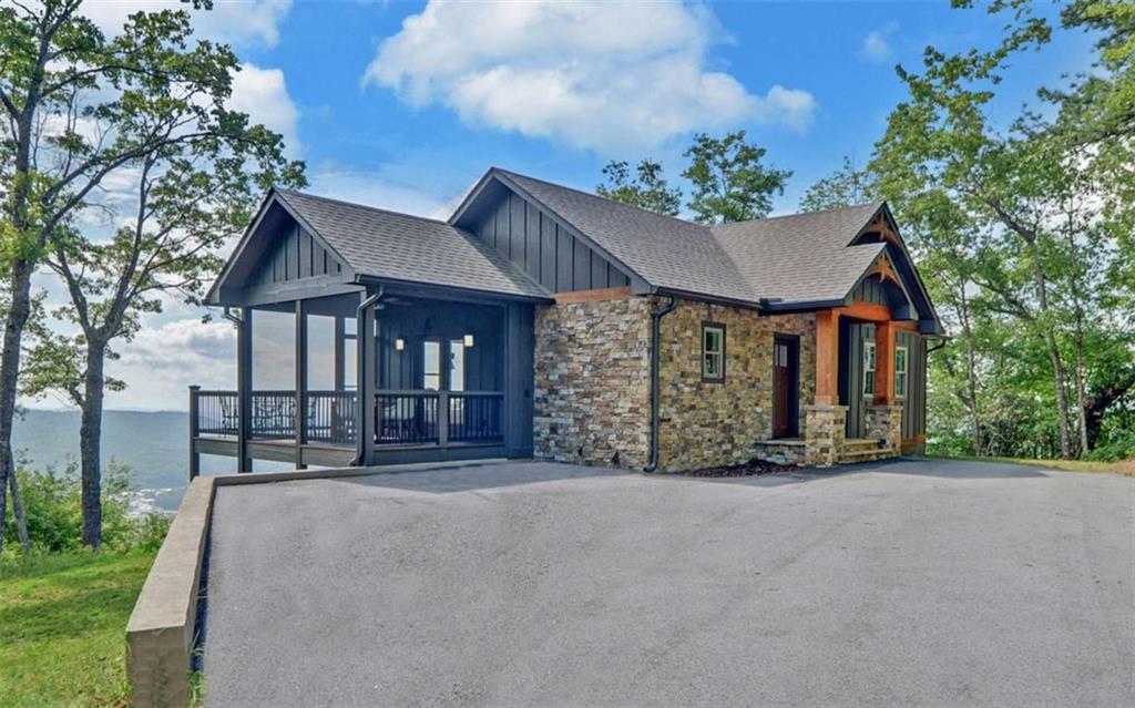 We welcome you to our beautiful 3 bedroom, 3.5 bath craftsman style mountain home in Rabun County, Ga. Enjoy one of the best views in Clayton at our just listed property in prestigious Black Rock Estates. This property is one mile from Main St. in Clayton--fun for all the shopping you may want to do in our unique shops and the first class restaurants with many serving farm to table. Clayton is the Farm to Table #1 City in Georgia! You can truly relax at the top of the mountain with views you thought were only in a book, listening to occasional wildlife as privacy, peace and quiet are your new best friends. Then, make a reservation at one of our fine restaurants and you and your family or friends can get ready for an unbelievable night in Clayton. It's the best of both worlds! You will love the privacy at the top of the mountain in your very own like new cabin built in 2023. As you enter the front door, you will immediately see the grand views from your living room, and then realize every area has beautiful views, no matter what window you are looking out of! The attention to detail is seen immediately with the vaulted ceiling and the exposed beams and tongue and groove. The hardwood floors on the Main level are beautiful. The handy door in the living room to the front deck is perfect when you are entertaining. Everything flows so well and is right at your fingertips! The colors in the cabin are tastefully done. The primary bedroom on the main floor is bright and cheery with a walk-in closet, a double vanity and large shower and, of course, beautiful views. The kitchen is the perfect size for entertaining while cooking at the same time. We all know where our guests and families always end up-the kitchen-and living room combo of kitchen and dining area and screened porch and deck are in a happy circle. The fireplace in the living room is perfect for those chilly evenings and watching the night view twinkle from the lights of the city. Downstairs, you have 2 bedrooms and two baths, a wet bar and the ability to walk out on your patio to the outside air--a perfect place for a hot tub and fire pit. The property is 3.00 acres, which includes some land on the other side of the road. This is an easy, enjoyable mountain home to own, close by Lake Burton, Lake Rabun and Seed Lake. Don't be spending your time cleaning and landscaping--Come to Rabun County and enjoy all we have to offer in outside activities! Make an appointment to see this home and open your eyes to the dream you have been having for years! It's right here waiting for you! The seller wants you know that his family bought this home primarily to celebrate Christmas in the mountains. His relatives from other states also come for the festivities. This year, they wanted to celebrate Christmas in July! Hope you enjoy our Christmas decorations as much as we have enjoyed this mountain home.