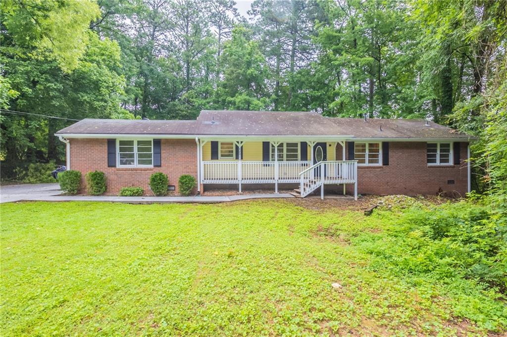 One or more photo(s) was virtually staged. This 3-bedroom, 2-bathroom single-story home offers great potential with a spacious layout and charming features like a covered front porch and a back deck, perfect for outdoor living. The home is in need of repairs, including missing flooring in some rooms, making it an ideal opportunity for investors or buyers looking to customize and add value. With a bit of work, this property could be transformed into a comfortable and inviting home. Don’t miss the chance to make it your own! Schedule a showing today!