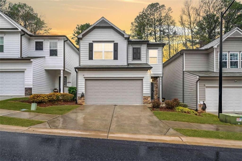 Modern Craftsman Style Home, built in 2020. The front porch sets the tone for this inviting residence. Inside, the open-concept living welcomes you into a bright and airy space. The kitchen features white cabinetry, stainless steel appliances, granite countertops, a breakfast bar, and a pantry. Off the kitchen is a dining area and a large family room with a cozy fireplace. Upstairs, a spacious loft provides opportunity for an office nook or flex space. The primary suite features trey ceilings and an oversized en suite bath featuring a soaking tub, walk-in shower, double vanities, a water closet, and a spacious walk-in closet. Two additional bedrooms share a full bath. Step outside onto the deck overlooking a private, fenced backyard that backs up to lush green space, offering a peaceful retreat. Located in the Etowah High School District. Close to Lake Allatoona, shopping and restaurants.