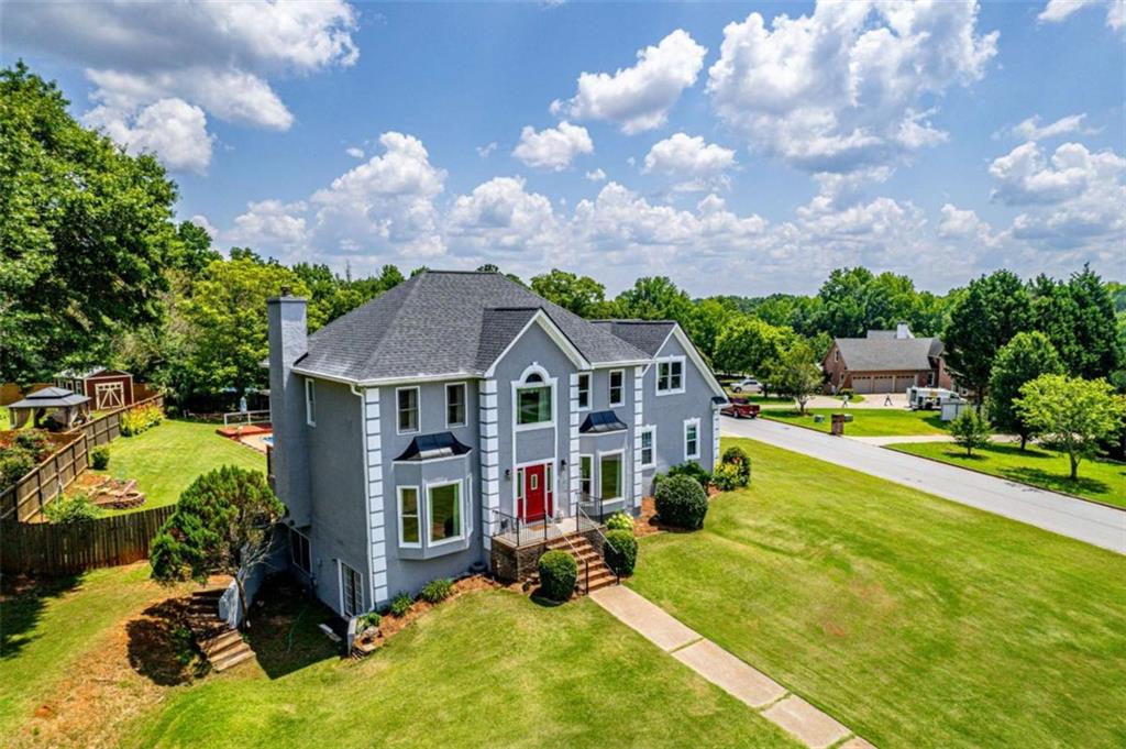 Welcome Home to 11 Chad Ct, McDonough, GA - A Private Retreat with Resort-Style Living. No HOA, Private Pool, Original Model Home, One Loving Owner. Discover timeless charm and modern luxury in this beautifully maintained 5-bedroom, 2.5-bath. The former model home is located in the desirable Bridge Water community with no HOA restrictions! Nestled on a peaceful cul-de-sac, this property offers a rare combination of space, privacy, and resort-style amenities-perfect for those who love to entertain or relax in their own backyard oasis. Interior Highlights: Thoughtfully Designed for Living & Entertaining. Step into a grand 2-story foyer featuring ceramic stone floors, dentil molding, and abundant natural light through sidelights and floor-to-ceiling windows. Elegant formal dining room with bay window and seating for 12+, plus a cozy office/living room with French doors for added flexibility. The spacious family room boasts a stone-surround gas fireplace, built-in wet bar, and floor-to-ceiling window, all overlooking the pool and lush backyard. A renovated chef's kitchen features Custom cabinetry by Duffey's of McDonough and granite countertops from Granco of McDonough. Premium stainless-steel appliances - LG fridge, trash compactor and downdraft cooktop. Oversized island, under-cabinet lighting, and easy access to the pool deck make this home ideal for entertaining! Beautiful hardwood flooring throughout the main level, plus a guest half bath for convenience. Outdoor Oasis: Resort-Style Backyard Perfect for Entertaining. Step outside and enjoy two expansive decks, a covered entertaining area, and a private 28' x 14' pool, complete with: Newer liner - 2019. Pool annually serviced by Georgia Pool, Privacy fencing, gazebo, and garden space. There is a storage shed for lawn equipment and pool supplies. Even a wedding-worthy setting-yes, a wedding has taken place by this stunning pool! Upstairs Retreats: Comfort Meets Functionality! Owner's suite with vaulted ceilings, custom walk-in closet, and a spa-like bathroom with: Dual vanities Oil-rubbed bronze fixtures, Jetted tub with picturesque window. Hall bathroom for guest has custom vanity from Duffey's and Granite from Granco-both out of McDonough, GA. There is an adjacent flex room that could be a nursery, office, or studio, with built-in desk. Three additional bedrooms with hardwood floors and large closets. Huge bonus room - ideal for a guest suite, gym, game room, or play area. Laundry is located upstairs-convenient and efficient! Basement&Storage: Expandable Living Space - Partially finished terrace level with heating & air-ready for your home theater, gym, or workshop. Secret hidden storage behind custom-built bookshelf. Sliding barn doors add character and separation of space. Additional Features: Upgrades & New roof (2021) by Peace of Mind with a 30-year warranty that is transferrable. Newer HVAC & water heater. New carpet (2025) with upgraded padding. Simply Safe Security System. Stunning landscape with palm trees and camellias. All TVs are included, even in the kitchen. Dual staircases for added convenience and architectural flair. Washer/dryer stay, along with LG stainless refrigerator. Why This Home? Lovingly maintained by only one family for over 35 years, this home is more than just bricks and mortar-it's a place where memories are made. From kids splashing in the pool to weddings in the backyard and cozy nights by the fireplace 11 Chad Ct is ready for the next chapter-and the next family to call it home. Location Highlights: Located minutes from schools, shopping, dining, and I-75, this home offers the perfect blend of seclusion and accessibility. Don't Miss This One-of-a-Kind Opportunity! Schedule your private showing today and experience the unmatched charm, quality, and lifestyle of 11 Chad Ct. Homes like this don't come along often-especially with no HOA, designer upgrades, and a private pool retreat!