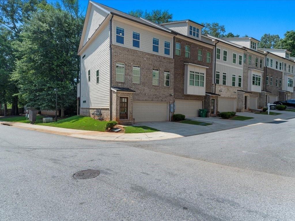 Welcome to your beautifully upgraded townhome, ideally located near entertainment, shopping, dining, Emory University, the CDC, Dekalb Medical, Marta, and Downtown plus a new Publix just around the corner! Step inside to find stunning hardwood floors throughout and a chef’s kitchen designed to impress, complete with stylish pendant lighting. The open main level features soaring 10-foot ceilings and large windows that flood the space with natural light, creating a warm and inviting atmosphere. As an end unit, this townhome offers a spacious dining and kitchen area that seamlessly flows into the family room, which leads out to a full rear deck surrounded by lush trees—perfect for relaxing or entertaining. With three levels of thoughtfully designed living space, you'll enjoy a generously sized suite on the Terrace level, along with a convenient 2-car garage that includes ample dedicated storage. Located in a small, gated community built by Water's Edge Group in 2019, this townhome truly has it all! Don’t miss your chance to experience comfortable living in this vibrant and well-connected neighborhood.