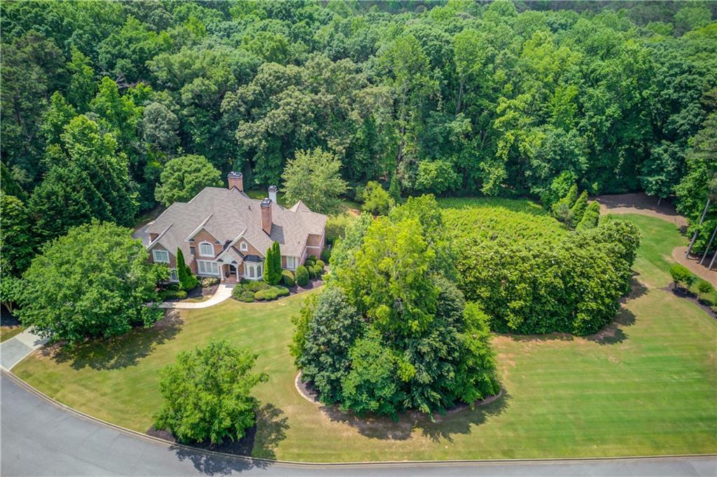 Welcome to this renovated executive brick estate, quality crafted by Milton Jones Construction and nestled in the exclusive gated section of White Columns—one of Milton's most desirable communities with top-rated schools.
Thoughtfully updated with luxurious finishes and exceptional craftsmanship, this home offers timeless elegance and modern comfort. The main level boasts a spacious primary suite and richly appointed office with floor-to-ceiling judges paneling. Five fireplaces add warmth and charm throughout, including in the sunlit living room with coffered ceilings and the beamed fireside keeping room.
The expansive gourmet kitchen is a chef’s dream, featuring a large center island, 48-inch gas range, custom vent hood, built-in ovens, and solid wood cabinetry. Refinished hardwood floors run throughout the main living spaces.
Perfect for multi-generational living, the finished daylight terrace level includes a fully self-contained in-law suite with a second gourmet kitchen that mirrors the main kitchen in style and scale, a separate laundry room, full bath, and private entrance.
Set on one of the largest and most private lots in the community, the level backyard is pool-ready and perfect for outdoor entertaining.
***SPECIAL FINANCING OPPORTUNITY!***
This home features an assumable VA loan with an incredible 2.49% interest rate!
Take advantage of this rare opportunity to assume a low-rate mortgage—significantly below today’s market rates! Qualified buyers can save thousands over the life of the loan.