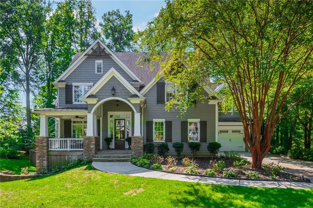 Welcome home to 150 Shady Grove Lane, a stunning custom residence by Ken McGarry Homes. This complete redesign offers the rare combination of a gorgeous wooded lot and unbeatable walkability—right in the heart of Downtown Alpharetta. This property is spacious on nearly a half-acre with a long, level driveway and perfectly set-back home to provide a large front yard. The backyard is truly captivating, featuring a 25-foot setback and preserved tree canopy with gorgeous oaks and hickories. The vaulted front porch sets the tone, welcoming you inside to a spacious home office with gas fireplace and serene views of the lush front yard and inviting porch. The thoughtfully designed kitchen is a true centerpiece, featuring a large seated island paired with contrasting honed granite counters, a gorgeous tile backsplash, and a gas range with griddle beneath a covered vent hood. A pot filler and farmhouse sink framed by windows overlooking the outdoors add both beauty and function. The dining area flows seamlessly into the family room, where a coffered ceiling, stone fireplace with hearth, custom built-ins, and expansive front-to-back windows create a light-filled space perfect for gathering. The main-level guest suite offers the ideal arrangement for generational living, blending comfort and convenience for extended family or visitors. A charming “friendship door” opens to a slate-accented hallway and mudroom, leading effortlessly to the casual porch room and the spacious three-car garage. To complete the main level and seamless flow, enjoy the expansive screened-in porch room designed with double fans, ample space for dining, lounge seating, and movie nights or football season —perfect for year-round gatherings. Upstairs, you’ll be greeted by a large, light-filled bonus room—an incredibly flexible space that can serve as a secondary living room. The primary suite impresses with a beautiful coffered ceiling and a spa-like bath featuring a frameless glass shower, free standing tub with polished feet, and a spacious walk-in closet. Three additional secondary bedrooms complete the upper level, each designed as a custom suite with direct bath access for comfort and privacy. From the moment you step inside, you’ll feel the custom touches that define this home—spanning over 4,000 square feet across two thoughtfully designed levels. The unfinished basement provides a blank canvas awaiting your personal design and future expansion.