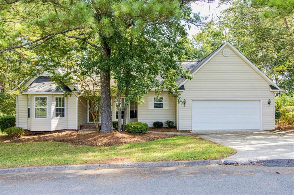 This inviting 4 bedroom, 2.5 bath ranch has been freshly painted throughout and has brand new carpet. Enter inside through the foyer into a vaulted great room with a cozy fireplace and beautiful views of the private backyard. The large kitchen offers an island with seating for barstools and a spacious dining area, perfect for everyday meals or entertaining. The oversized owner's suite includes a generous bathroom and two closets.Across the home, three additional bedrooms share a full bathroom, providing plenty of room for family or guests. A freshly stained deck extends your living space outdoors, overlooking the private backyard. Move-in ready, this home is ready for its next owner!