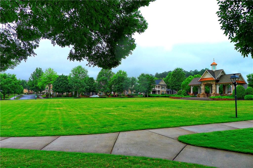 WOW IF YOU’VE BEEN WAITING FOR SPECTACULAR VILLAGE GROVE- HERE’S YOUR WINNER!! Perched directly on the community’s largest park, the size of a football field, this luxury townhome enjoys huge panoramic views of this lush open conservation space! Some of the awesome features: 2-car garages; Full guest suite on main level with private bath! Office/ technology center for home office. Main level boasts an entertaining “open concept” floor plan. Fireplace. Gourmet chef’s kitchen with giant views of huge park- and only steps from Village Grove’s popular swim/ tennis/ and clubhouse amenity center… Upper level of home has 2BRs and 2 full BAs, with master featuring soaking tub. Fresh, clean carpet. Tall ceilings. Brand new roof. Refrigerator/ washer & dryer remain. Stunning curb appeal- construction of stone & Hardiplank. And wonderful trim package make this particular townhome a clear winner… Literally walking distance to upscale restaurants- sushi, CVS, Kroger, and tons and tons of other shoppes! Clean pet-free home owned by Mrs Clean- and priced correct for today’s market. Showings start Saturday morning...