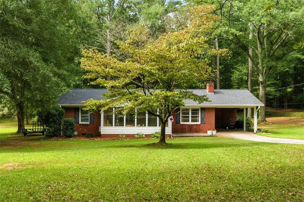 Welcome to this beautifully renovated 4-sided brick country cottage brimming with character and modern upgrades. Nestled on nearly an acre in Carroll County, this 3-bedroom, 1-bath home offers the perfect balance of charm and functionality.
Step into the sun-filled kitchen featuring brand-new granite countertops, custom cabinetry, stainless steel appliances, and a spacious island ideal for meal prep or gathering with friends. The open-concept dining area centers around a stunning brick fireplace, creating a cozy atmosphere for entertaining or everyday living.
Enjoy abundant natural light from the inviting front sunroom and the warmth of new hardwood-style floors throughout. Additional upgrades include newer roof, HVAC, tankless water heater, and more—ensuring comfort and peace of mind.
Outside, the .84-acre lot provides plenty of room for gardening, outdoor living, or simply relaxing in your private backyard retreat. With a 2-car carport and convenient location just minutes from Mount Zion schools, this home truly has it all.
Don’t miss your chance to own this move-in ready gem—schedule your showing today!