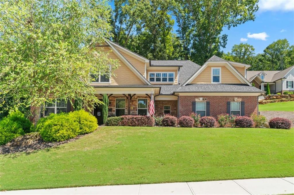 Welcome home to this stunning 5 bedroom, 3 bathroom residence in the highly desirable, gated Scenic Falls neighborhood. Featuring an ideal layout with the primary suite on the main level, this home offers both convenience and comfort. Step inside to find an open-concept kitchen with beautiful cabinetry, stainless steel appliances, and a large center island, perfect for meal prep or casual dining. The kitchen flows seamlessly into the cozy living area and sunny eat-in space, creating the perfect setting for gatherings. A unique built-in nook under the stairs, complete with a secure gate, provides the perfect spot for your furry friends. The main-level owner's suite features a spacious walk-in closet, a soaking tub, and a tiled walk-in shower with bench seating. An additional bedroom and full bathroom are also located on the main floor. Upstairs, you'll find two more bedrooms, a full bath, and a generous bonus room that can be used as a fifth bedroom, home office, or playroom. Step outside to enjoy a private screened-in porch overlooking the beautifully landscaped yard. The backyard offers a true retreat with a large fenced lawn, sitting area, and plenty of space for outdoor entertaining or quiet relaxation. Scenic Falls residents enjoy exceptional amenities including a clubhouse, swimming pool, and tennis courts. Conveniently located just minutes from I-85, this home offers both a peaceful retreat and easy access to shopping, dining, and commuting.